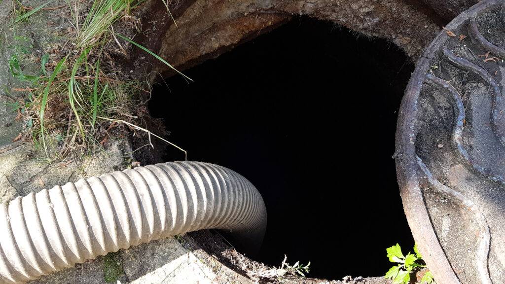 Hose Lowered Into Sewer